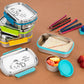 Munchy lunch boxes in different colors with colorful food items around stationary to depict ideal for school going children